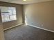 Clean bedroom featuring plush carpet, neutral paint, and a large window at 5942 King Way Walk, Lithonia, GA 30058