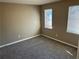 Neutral bedroom featuring plush carpet, fresh paint, and natural light at 5942 King Way Walk, Lithonia, GA 30058