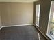 Cozy bedroom featuring neutral paint, plush carpet, and two large windows for natural light at 5942 King Way Walk, Lithonia, GA 30058