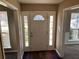 Inviting foyer featuring a white door with sidelights and transom window, and dark wood flooring at 5942 King Way Walk, Lithonia, GA 30058