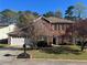 Traditional brick home with well-manicured lawn and mature landscaping at 5942 King Way Walk, Lithonia, GA 30058