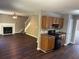 Open-concept living space with a fireplace, wood floors, and stairs leading to the second floor at 5942 King Way Walk, Lithonia, GA 30058