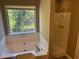 A luxurious main bathroom with a separate shower and jetted tub at 5942 King Way Walk, Lithonia, GA 30058