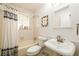 Cozy bathroom featuring a shower-tub combo, toilet, and sink with a white-themed color scheme at 1448 N Highland Ne Ave, Atlanta, GA 30306