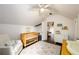 Charming Bedroom with white walls, ceiling fan, wood crib and an ornate rug in the center at 1448 N Highland Ne Ave, Atlanta, GA 30306