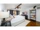 Bedroom showcasing a king bed, a dresser, a TV, hardwood floors, and a ceiling fan at 1448 N Highland Ne Ave, Atlanta, GA 30306