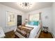 Serene bedroom featuring a plush bed, stylish decor, and plenty of natural light at 1448 N Highland Ne Ave, Atlanta, GA 30306