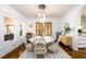 Bright dining room featuring a white round table with seating for six and a modern chandelier at 1448 N Highland Ne Ave, Atlanta, GA 30306