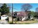 Traditional home with a blooming tree in the yard and detached garage with driveway at 1448 N Highland Ne Ave, Atlanta, GA 30306