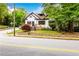 Charming two-story home with stone and grass landscaping surrounded by greenery on a sunny day at 1448 N Highland Ne Ave, Atlanta, GA 30306
