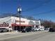 The Gathering Dog and Highland Fine Wine, a lively street view with vibrant businesses and active parking at 1448 N Highland Ne Ave, Atlanta, GA 30306