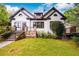 Charming two-story home with white painted brick, dark trim, landscaped yard, and stone accent wall at 1448 N Highland Ne Ave, Atlanta, GA 30306