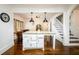 Kitchen island featuring granite countertop and access to adjacent living area and staircase at 1448 N Highland Ne Ave, Atlanta, GA 30306