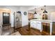 Bright kitchen island with stainless steel refrigerator and view into the dining and living areas at 1448 N Highland Ne Ave, Atlanta, GA 30306