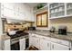 Bright kitchen with stainless steel appliances, white cabinets, and decorative tile backsplash at 1448 N Highland Ne Ave, Atlanta, GA 30306