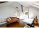 Loft with a brick accent wall, hardwood floors, a brown leather couch, and an office area at 1448 N Highland Ne Ave, Atlanta, GA 30306