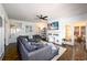 Open living room with hardwood floors, a modern fireplace, and a large sectional sofa at 1448 N Highland Ne Ave, Atlanta, GA 30306