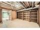 Spacious unfinished basement featuring wood paneling, shelving, and utility connections at 510 Ponce De Leon Ne Mnr, Atlanta, GA 30307