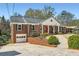 Side view of the brick home featuring a driveway and garage at 510 Ponce De Leon Ne Mnr, Atlanta, GA 30307