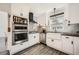 Bright kitchen featuring white cabinets, modern appliances, and gray backsplash at 510 Ponce De Leon Ne Mnr, Atlanta, GA 30307