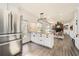 Open concept kitchen with white cabinets, butcher block island, and a view of the living room at 510 Ponce De Leon Ne Mnr, Atlanta, GA 30307