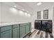 Modern laundry room with front-load washer and dryer and lots of counter space at 510 Ponce De Leon Ne Mnr, Atlanta, GA 30307