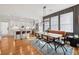 Open-concept dining area with hardwood floors, a stylish banquette, and a modern kitchen at 969 Parsons Sw St, Atlanta, GA 30314