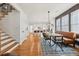 Bright dining area connected to a modern kitchen with hardwood floors and staircase at 969 Parsons Sw St, Atlanta, GA 30314