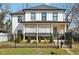 Charming two-story home featuring a well-manicured lawn and black metal fencing at 969 Parsons Sw St, Atlanta, GA 30314