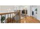 Bright hallway with wood floors, iron railings, and decor leading to laundry room at 969 Parsons Sw St, Atlanta, GA 30314