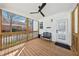Charming covered porch with wooden floors, ceiling fan, and a cozy bench for relaxing outdoors at 969 Parsons Sw St, Atlanta, GA 30314