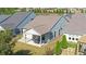 Overhead view of a home with a covered patio and well-kept lawn surrounded by lush landscaping in a residential area at 5638 Maple Bluff Way, Hoschton, GA 30548