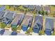 Drone view showing a residential neighborhood featuring well-maintained houses with landscaped yards and paved streets at 5638 Maple Bluff Way, Hoschton, GA 30548