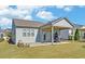 Well-manicured backyard with a covered patio, offering a delightful space for outdoor gatherings and relaxation at 5638 Maple Bluff Way, Hoschton, GA 30548