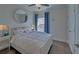 Comfortable bedroom featuring a large window with cozy decor and hardwood floors at 5638 Maple Bluff Way, Hoschton, GA 30548