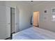Bright bedroom with a closet and white color scheme offering a clean and peaceful ambiance at 5638 Maple Bluff Way, Hoschton, GA 30548