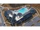 Aerial view of the community clubhouse with an outdoor pool, lounge area, and ample parking at 5638 Maple Bluff Way, Hoschton, GA 30548