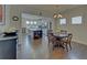 Open dining room with wood floors, chandelier, and view into modern kitchen at 5638 Maple Bluff Way, Hoschton, GA 30548