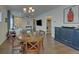 Cozy dining area leads to the living room, featuring hardwood floors and modern lighting creating an open concept at 5638 Maple Bluff Way, Hoschton, GA 30548