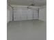 Spacious garage with an epoxy floor, providing a clean and durable space for vehicles and storage at 5638 Maple Bluff Way, Hoschton, GA 30548