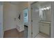 Hallway area features a coat rack bench and a bathroom providing storage and functionality at 5638 Maple Bluff Way, Hoschton, GA 30548