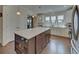 Bright eat-in kitchen with white cabinets, stainless steel appliances, and center island with storage at 5638 Maple Bluff Way, Hoschton, GA 30548