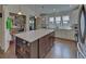 Bright eat-in kitchen with white cabinets, stainless steel appliances, pantry, and center island with storage at 5638 Maple Bluff Way, Hoschton, GA 30548