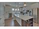 Kitchen featuring stainless appliances, white cabinets, quartz counters, and center island with storage at 5638 Maple Bluff Way, Hoschton, GA 30548