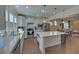 Modern kitchen featuring stainless appliances, white cabinets, quartz counters, and open layout at 5638 Maple Bluff Way, Hoschton, GA 30548