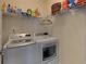 Well-equipped laundry room with washer, dryer, and shelving for efficient organization at 5638 Maple Bluff Way, Hoschton, GA 30548