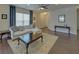 Bright living room features hardwood floors, plush seating, and ample natural light for a comfortable space at 5638 Maple Bluff Way, Hoschton, GA 30548