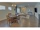 Stylish dining area seamlessly flows into a living room, offering a bright and open space for entertaining at 5638 Maple Bluff Way, Hoschton, GA 30548