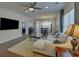 Inviting living room with hardwood floors, sectional sofa, and large windows, creating a cozy atmosphere at 5638 Maple Bluff Way, Hoschton, GA 30548