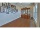 Bright living room with hardwood floors, large window, and antique china cabinet at 5638 Maple Bluff Way, Hoschton, GA 30548